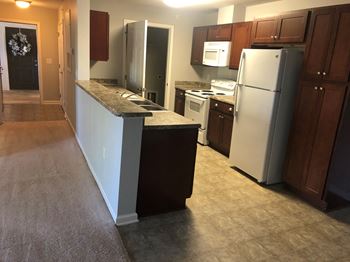 Kitchen with a refrigerator, microwave, and oven.